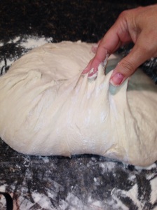 Shaping the dough into a round.